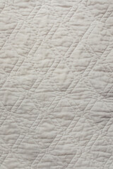 White quilted diamond shape mattress pad bed blanket texture 