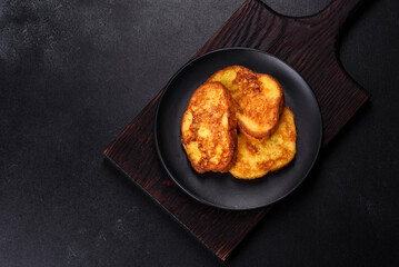 Cereal with chocolate, milk and bread in an egg against a dark concrete background