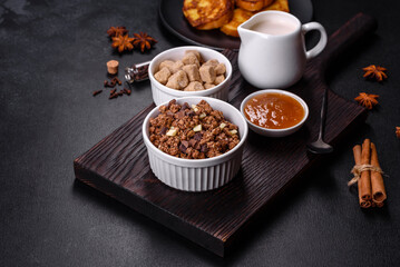 Cereal with chocolate, milk and bread in an egg against a dark concrete background