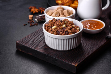 Cereal with chocolate, milk and bread in an egg against a dark concrete background