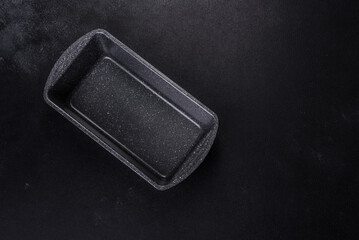 An empty ceramic grey baking dish on a dark concrete background