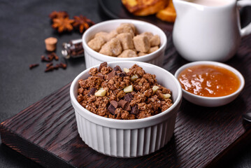 Cereal with chocolate, milk and bread in an egg against a dark concrete background