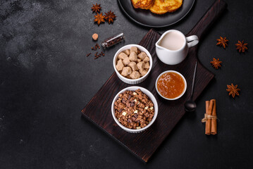 Cereal with chocolate, milk and bread in an egg against a dark concrete background