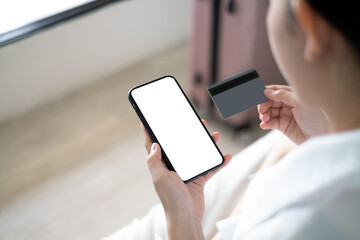 Woman using credit card to book hotel online