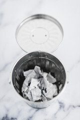 writer's block concept, garbage bin with scrunched paper inside of it