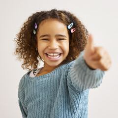 This has my stamp of approval. Shot of an adorable little girl standing alone and showing a thumbs up.