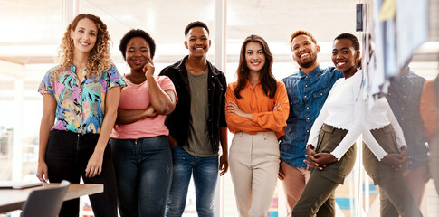 The team you need. Cropped portrait of a group of young designers standing in the boardroom of...