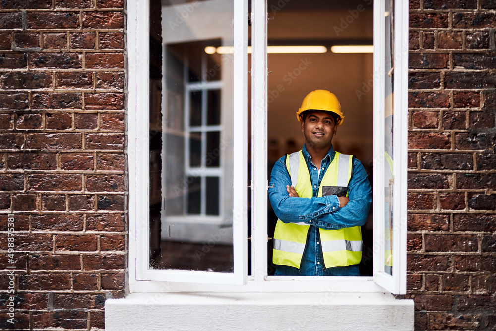 Aufkleber My team and I are going to transform this building. Shot of a young engineer standing in the window of a construction site.