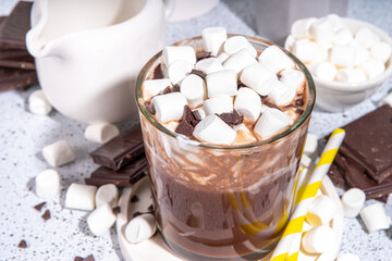 Refreshing Iced Hot Chocolate cocktail, milk sweet chocolate cold drink with marshmallow, white background copy space