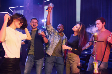 Enjoying free time in the night club. Group of friends having fun together