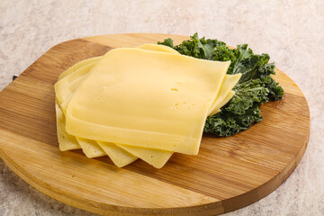 Sliced Gouda cheese over board