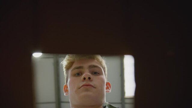 Point of view shot of male intern in distribution warehouse closing and sealing box - shot in slow motion