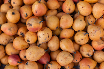 Ripe juicy yellow pears on the store counter