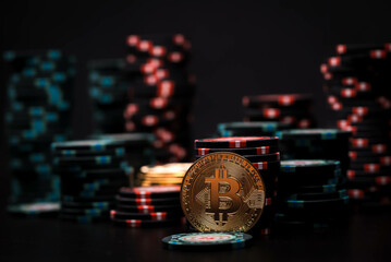 Closeup of bitcoin coin near casino playing chips. Bitcoin casino game. Cryptocurrency excitement....