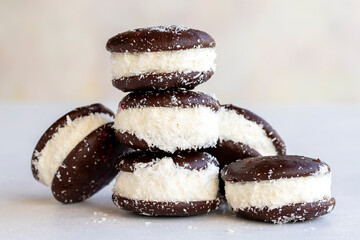 Chocolate biscuit with milk filling. Cake with milk filling on a white background. Chocolate-milk kids dessert. Bakery products. Close-up. local name sut dilimi