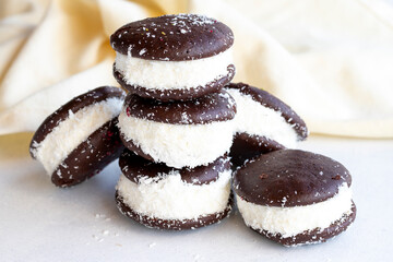 Chocolate biscuit with milk filling. Cake with milk filling on a white background. Chocolate-milk kids dessert. Bakery products. Close-up. local name sut dilimi