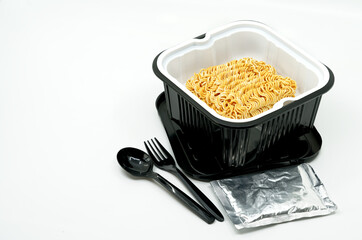 Instant noodles in a black plastic bowl