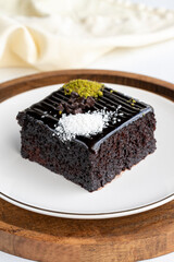 Chocolate moist cake. Wet cake in a plate. Bakery products. Close-up.