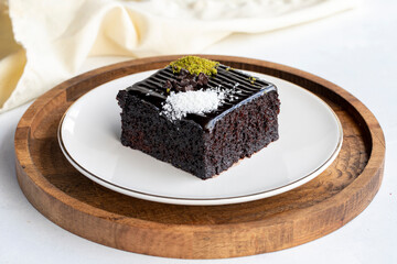 Chocolate moist cake. Wet cake in a plate. Bakery products. Close-up.