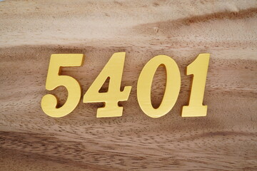 Golden Arabic numerals on a real brown and white wooden floor number 5401
