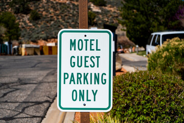 Motel guest only parking sign