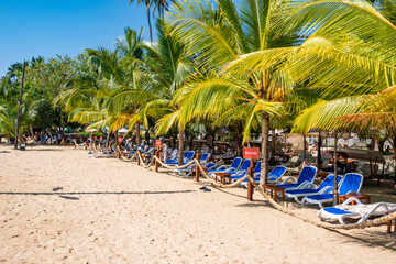 Sunbeds and umbrella on a tropical private beach