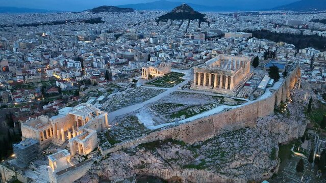 night view of Acropolis in Athens, flying above illuminated Parthenon in Athens in the evening, night view of downtown Athens, international landmark in Greece