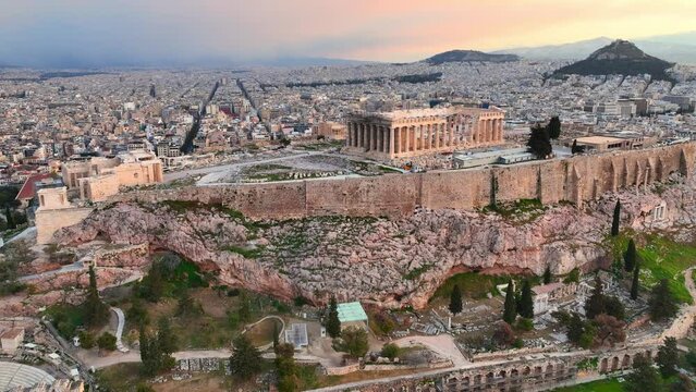 Flying towards the Parthenon of Athens at dawn, sunrise in Greek capital Athens, aerial view of Acropolis, classical ancient Greek monument