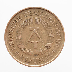 Germany East GDR - circa 1969 : a five German Mark coin of the GDR with the Hammer and circle coat...
