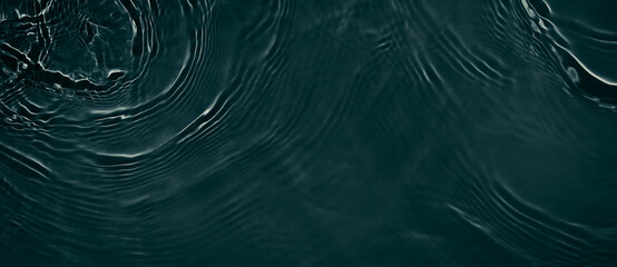 Black transparent clear calm water surface texture with ripples, splashes. Abstract nature banner...