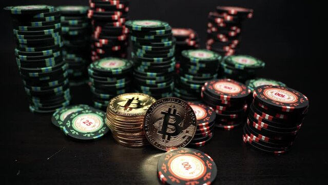 Rotation of the camera over a bitcoin coin against the background of casino playing chips. Bitcoin casino game. Cryptocurrency excitement. Bet on bitcoins.