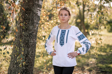 Fototapeta na wymiar The girl, the Ukrainian in an embroidered shirt, the girl in an embroidered shirt