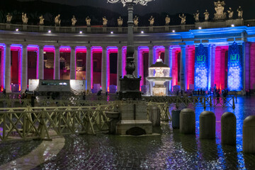 Fototapeta na wymiar St. Peter's Square for the holidays on a rainy evening, Italy