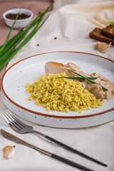 Halibut fillet with bulgur and creamy lemon sauce. Cooked fish fillet with garnish in ceramic dishware. Modern food in a minimalist style. Beautiful serving of the dish.