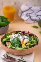 Healthy breakfast. Green salad with fresh avocado, poached egg and seeds chia. Vegetarian food concept. Copy space. Delicious appetizer, breakfast, lunch or brunch.