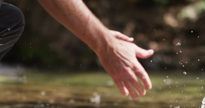 Fly fishing fish caught in hands a drops to water slowmo
