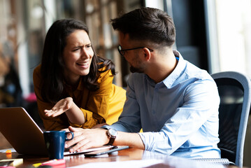 Colleagues in office. Businesswoman and businessman discussing work in office.
