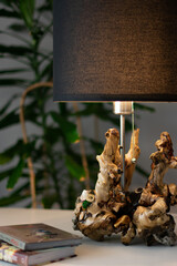Unique handmade table lamp made of driftwood in the interior