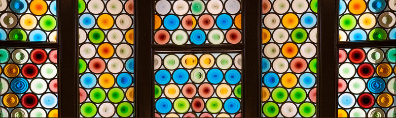 Old round stained glass window in a historic building