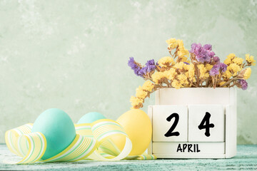 cube calendar for easter on table decorated with colorful eggs