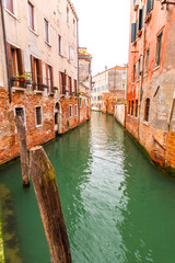 Fototapeta na wymiar Beautiful canals and traditional Venetian buildings in Venice, Italy