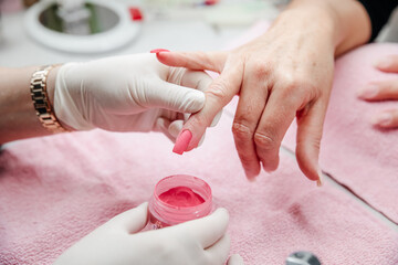Manicure treatment at nail salon, hands closeup. Professional manicure in beauty salon.
Woman in nail salon receiving manicure. Hygiene and care for hands. Beauty industry concept