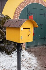 yellow mailbox in front of the house on the street
