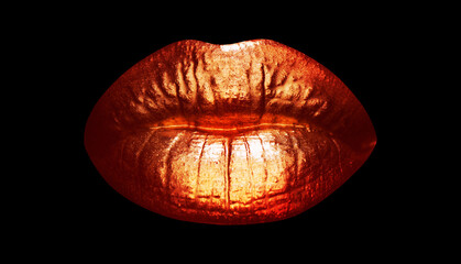 Womans golden lips close up isolated background. Gold sexy mouth.