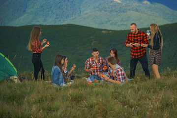 Group of youth at summer festival. Camping season. Young people at summer music festival. Funny group of young girls and boys at music festival.