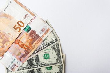 banknotes of dollars, euros and rubles on a white background with a calculator