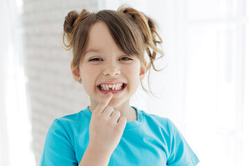 The kid lost a tooth. Baby without a tooth. Portrait of a little girl no tooth. High quality photo