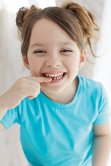 The kid lost a tooth. Baby without a tooth. Portrait of a little girl no tooth. High quality photo - 498901570