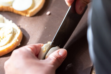 Obraz na płótnie Canvas Close-up sandwiches with a hard-boiled egg. Preparation of breakfast.