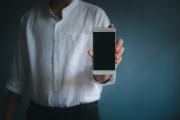 Business man using smartphone on blur background.